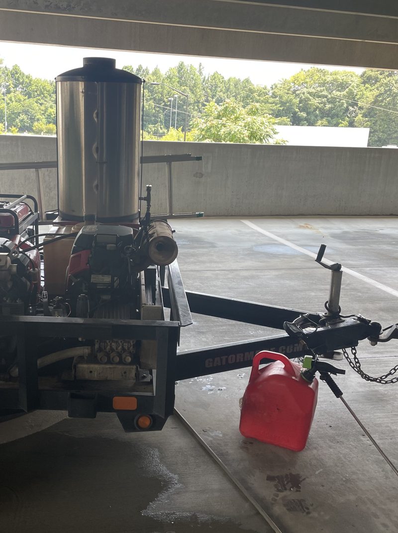 Washing a level of an occupied parking deck, vehicles still in place